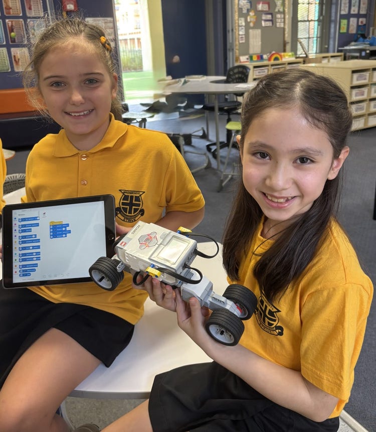 Two students with an iPad and LEGO robot