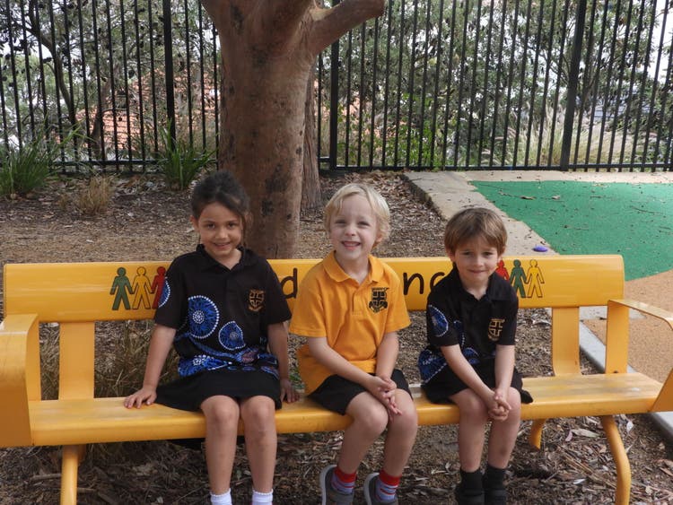 chilcren sitting on a bench seat